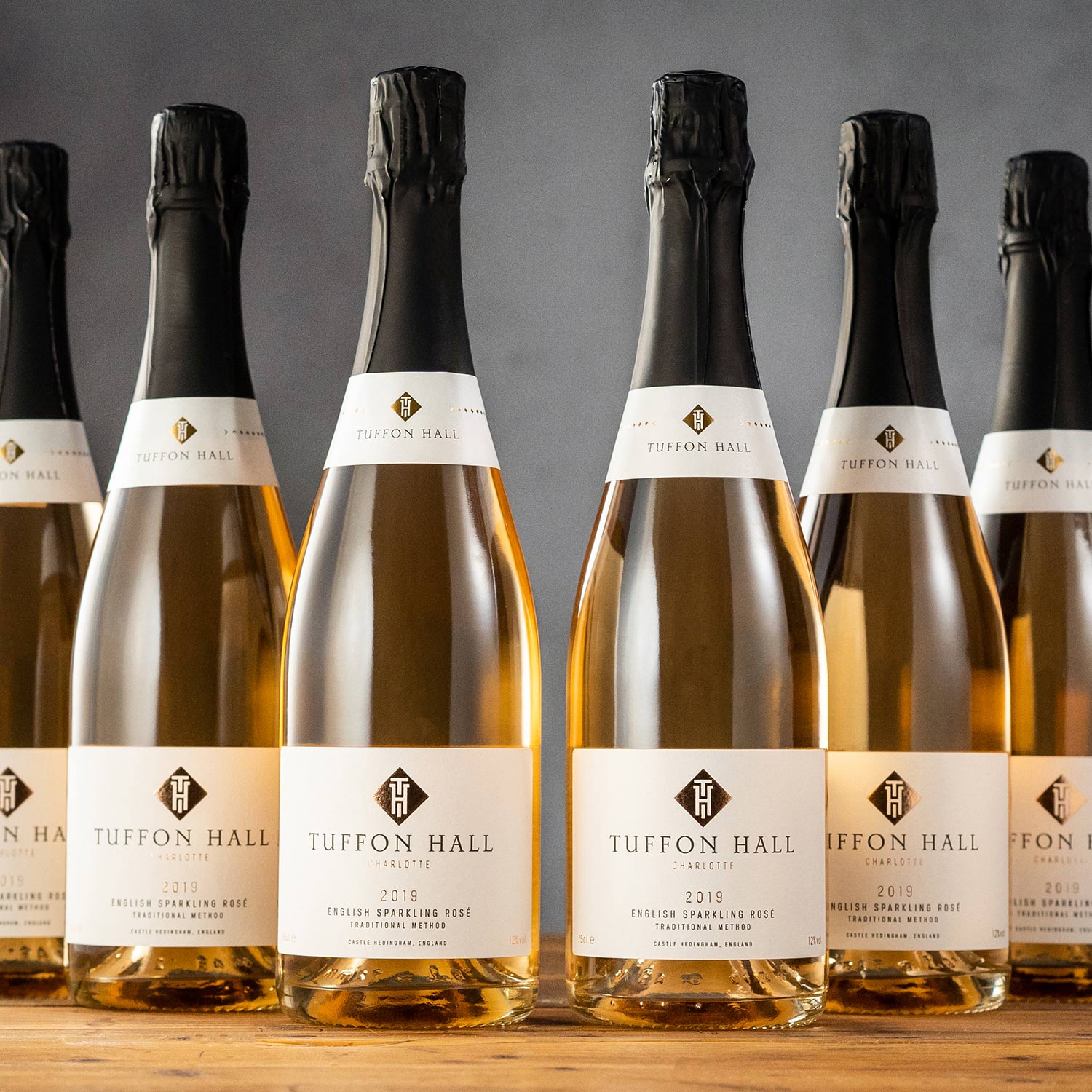 A glass and bottle of Tuffon Hall Cuvee Sparkling White